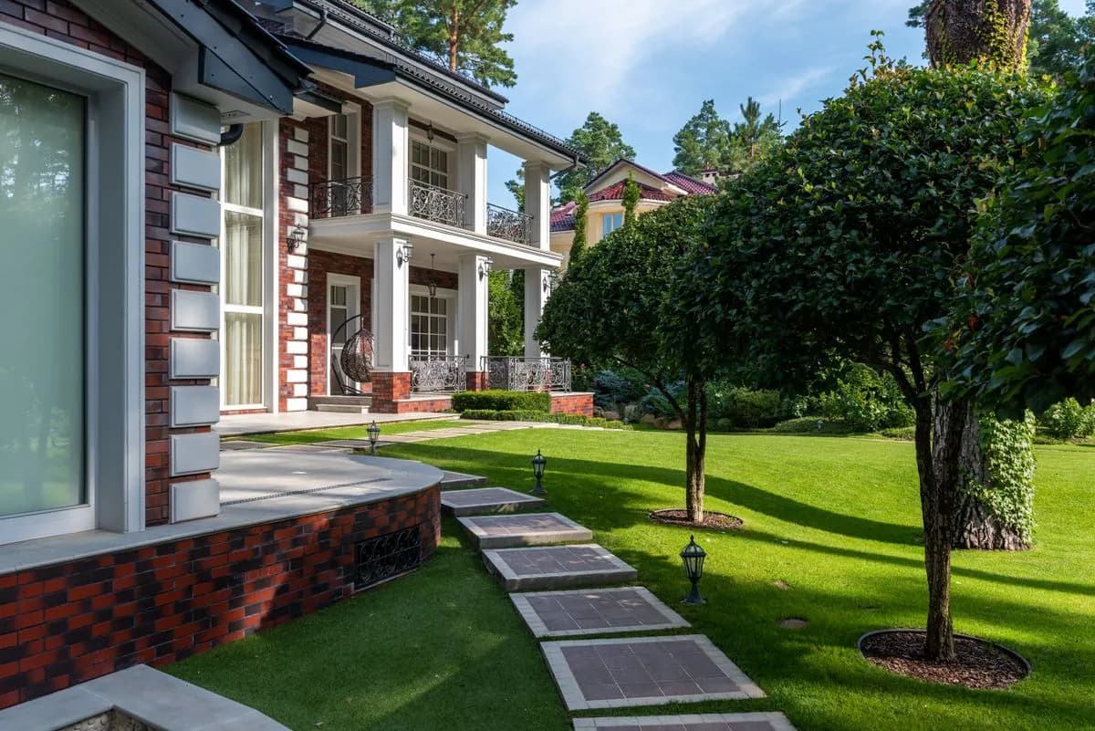 Villa lawn with natural stone stepping pads linking the pool terrace and house, Dubai Hills