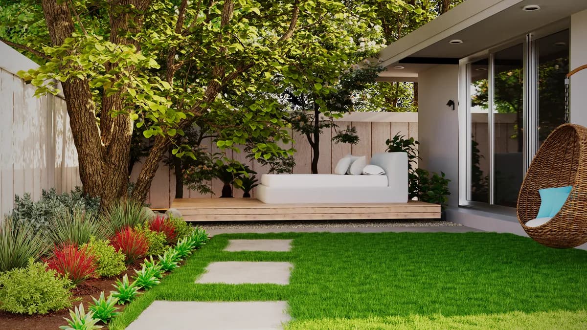 Modern backyard lawn bordered by frangipani, bougainvillea and desert planting at a Dubai Hills villa