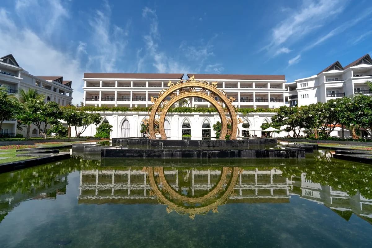Hotel building reflected in a restored granite-lined reflecting pool, Sharjah