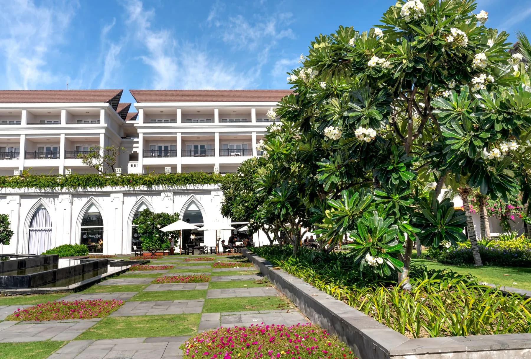Boutique hotel in Sharjah with a formal courtyard garden of clipped hedging and palm avenues, designed by Absher Landscaping