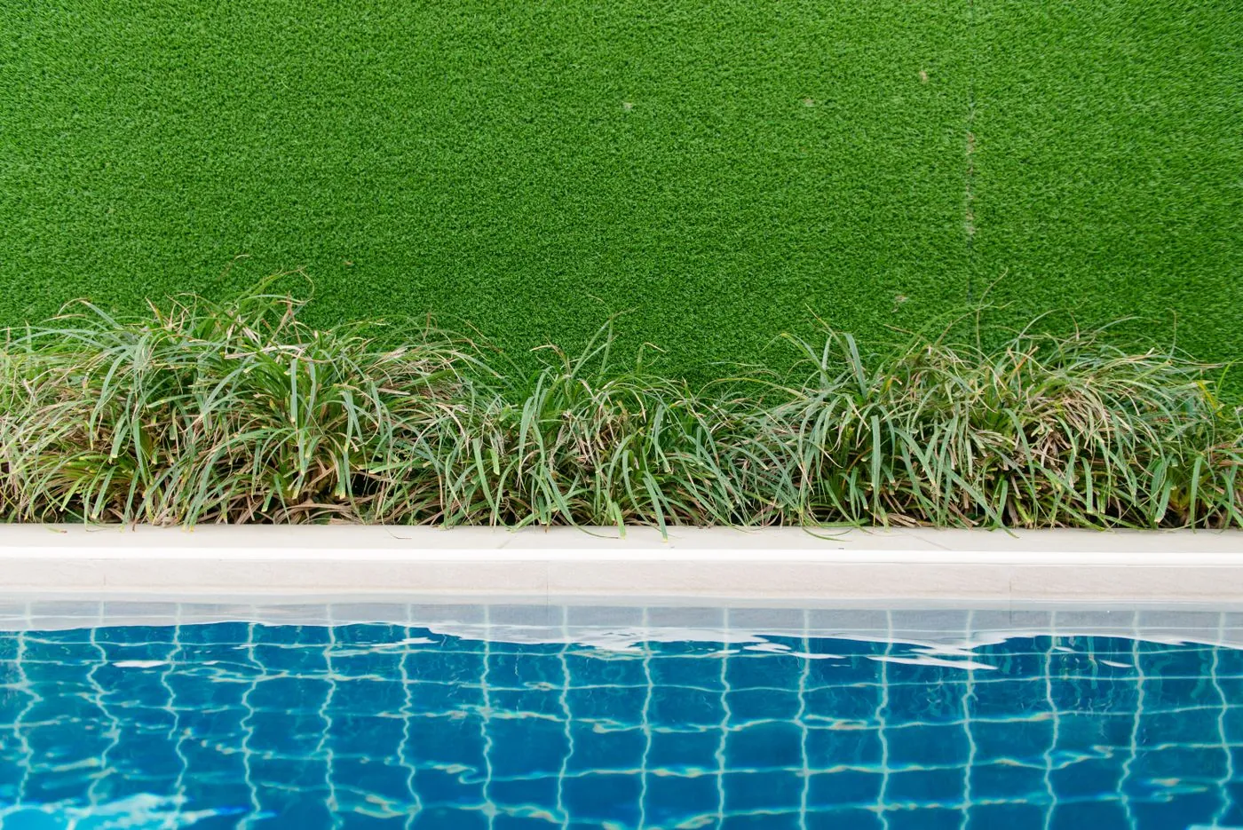 Immaculate artificial grass lawn in a modern UAE villa garden installed by Absher Landscaping