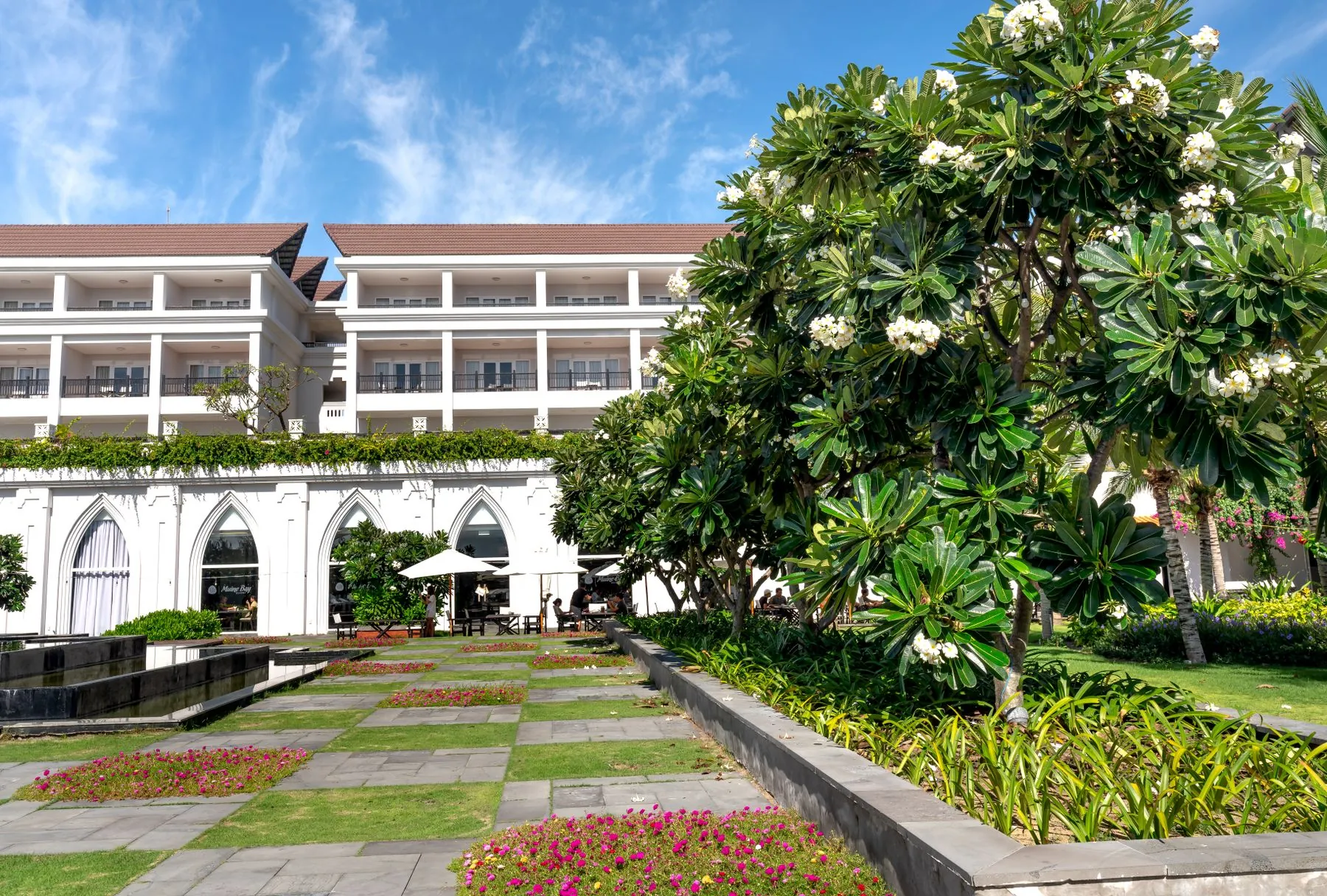 Boutique hotel in Sharjah with a formal courtyard garden of clipped hedging and palm avenues, designed by Absher Landscaping