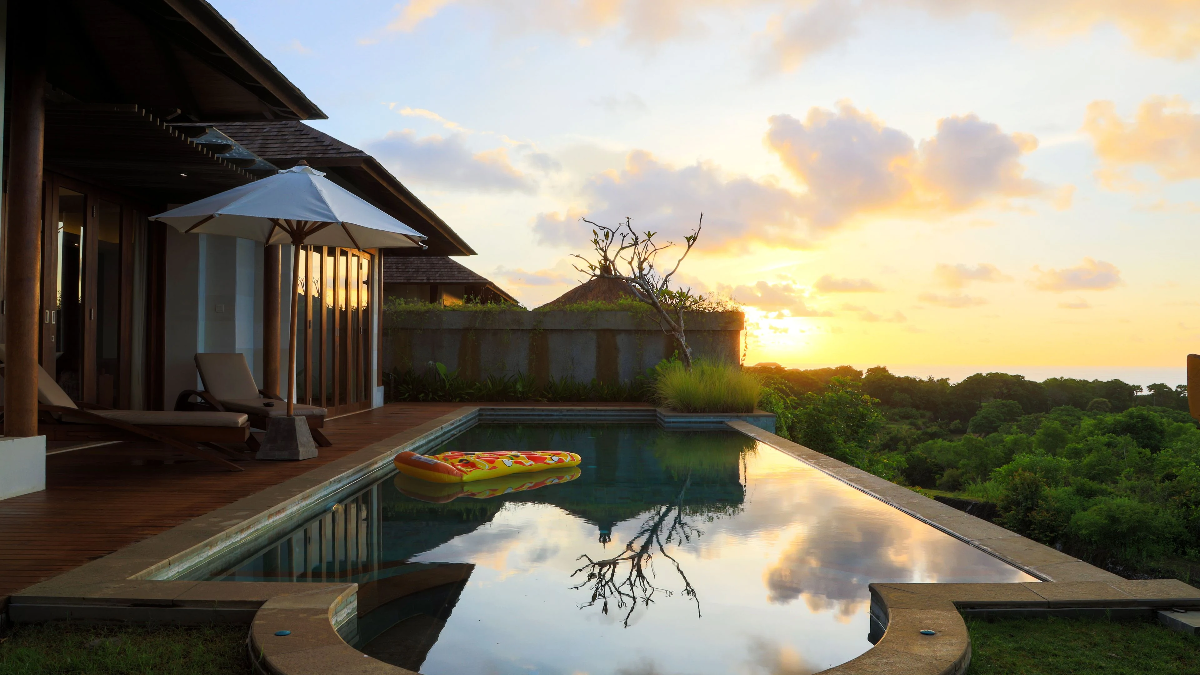 Villa swimming pool and garden at sunset in the UAE