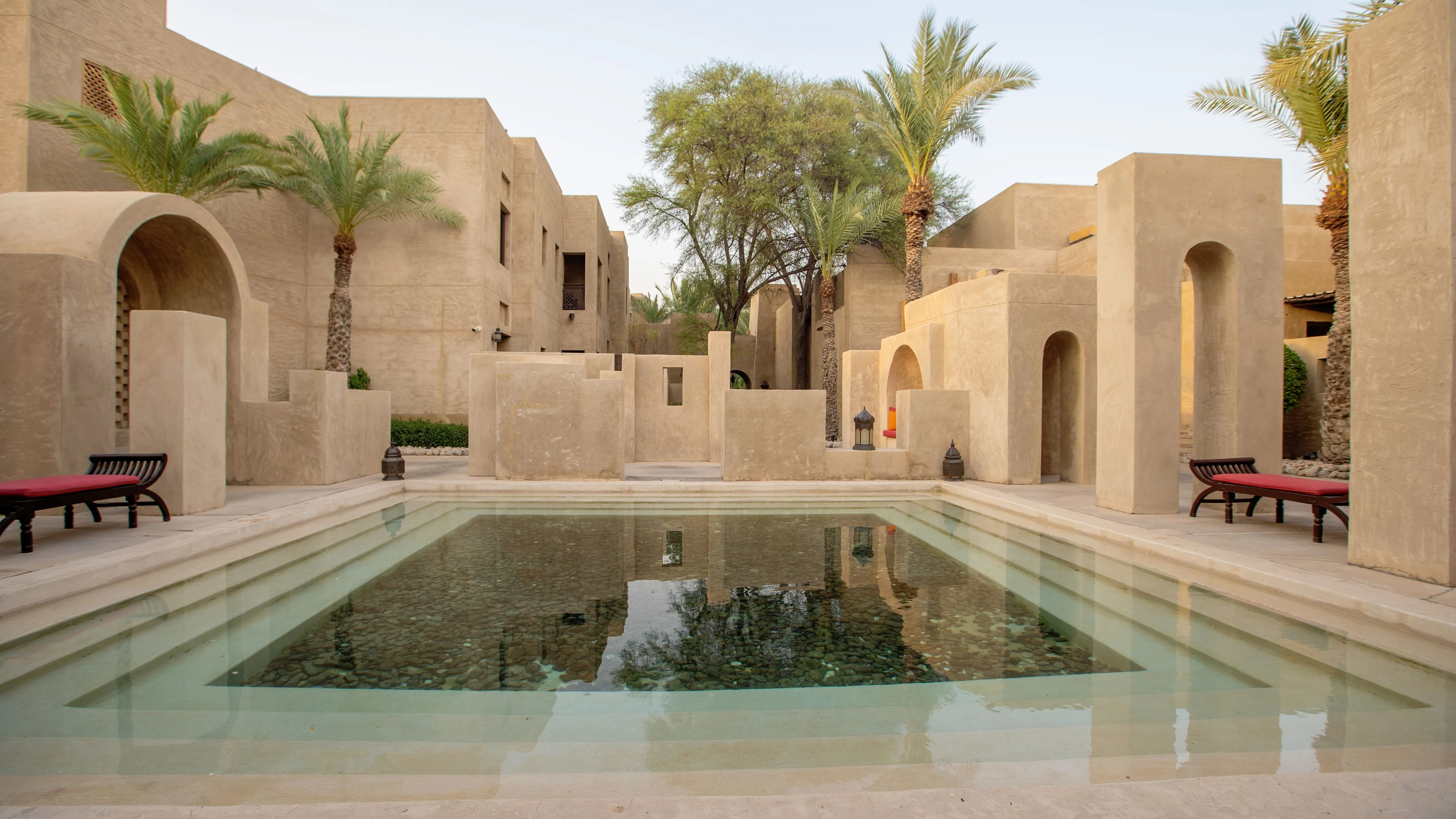 Traditional Arabic courtyard with reflecting pool and palm trees
