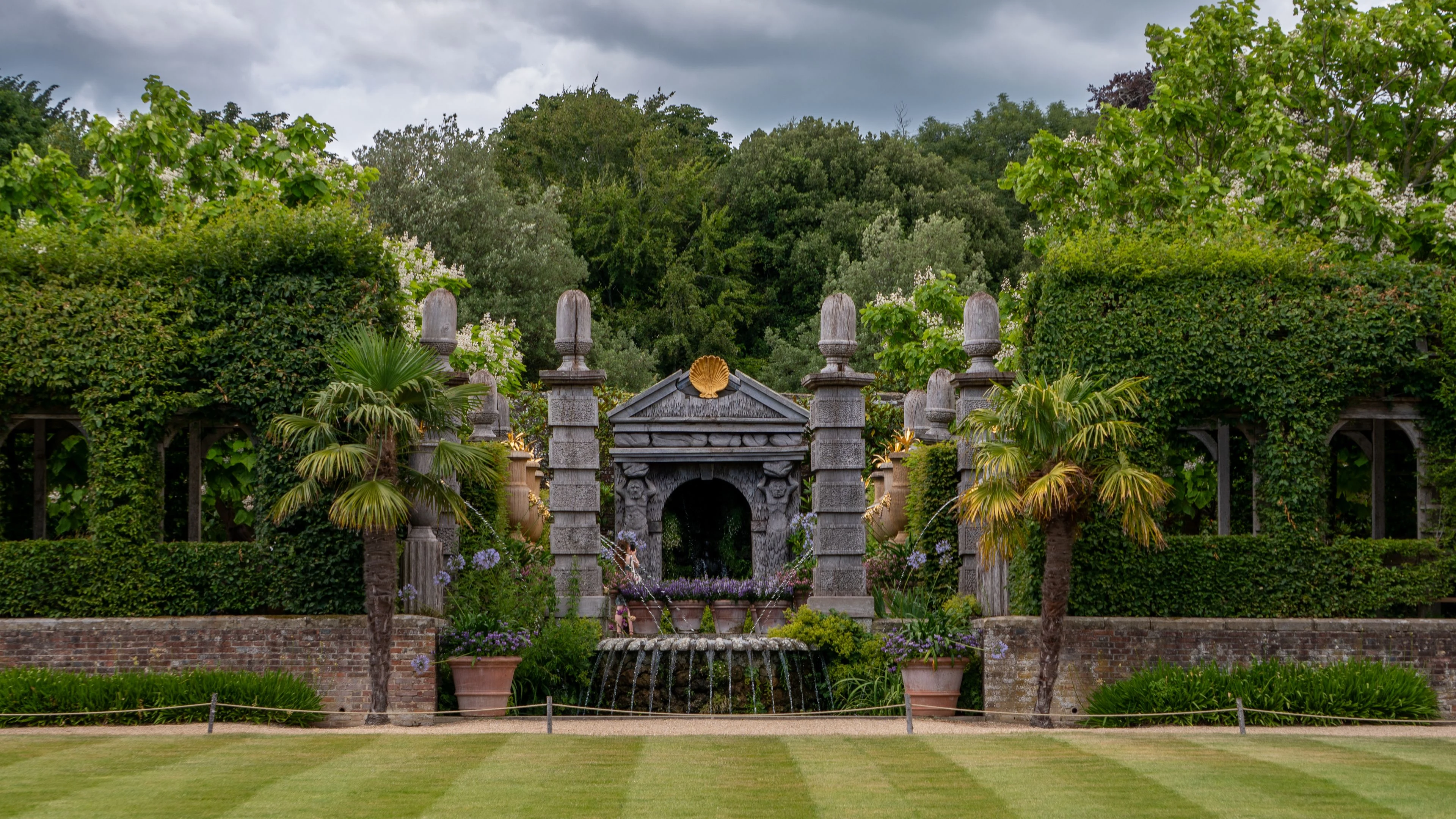 Formal garden with clipped hedges and palms
