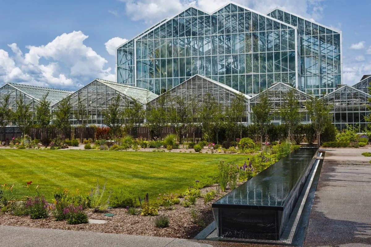 Glass office building with a uniformly green lawn on a Dubai business park campus